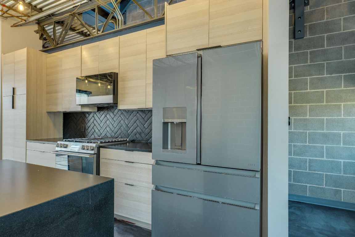 4801 South Congress Avenue, Unit S3 Austin, TX 78745 - Photo 7 of 40 a kitchen with a refrigerator and a sink