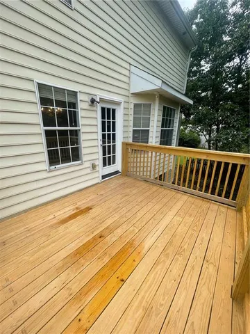 a view of a house with deck and wooden floor