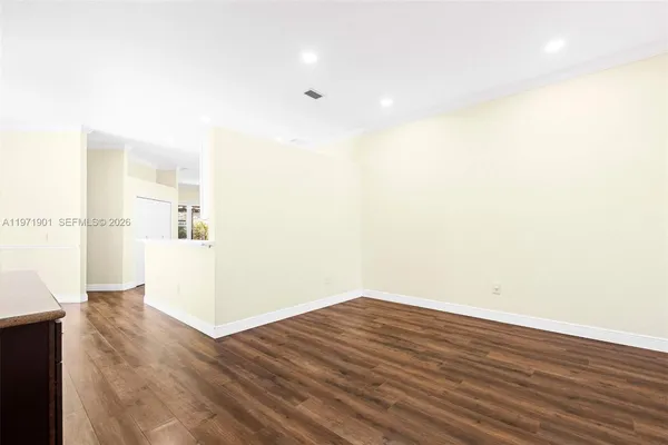 a view of a room with wooden floor and a bathroom