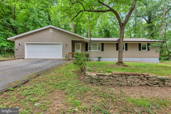 a house with green field in front of it