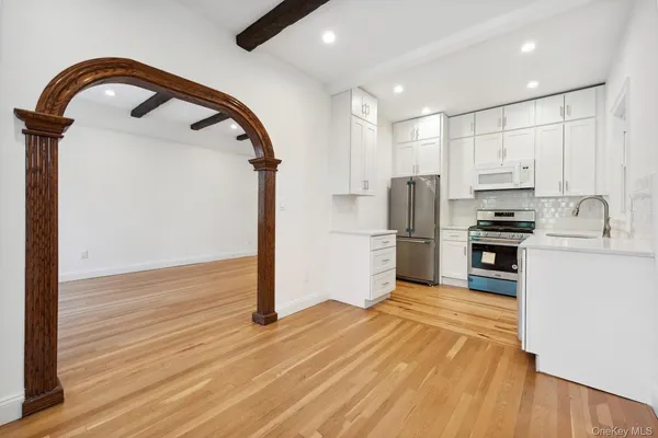 a kitchen with stainless steel appliances granite countertop a refrigerator and a stove top oven