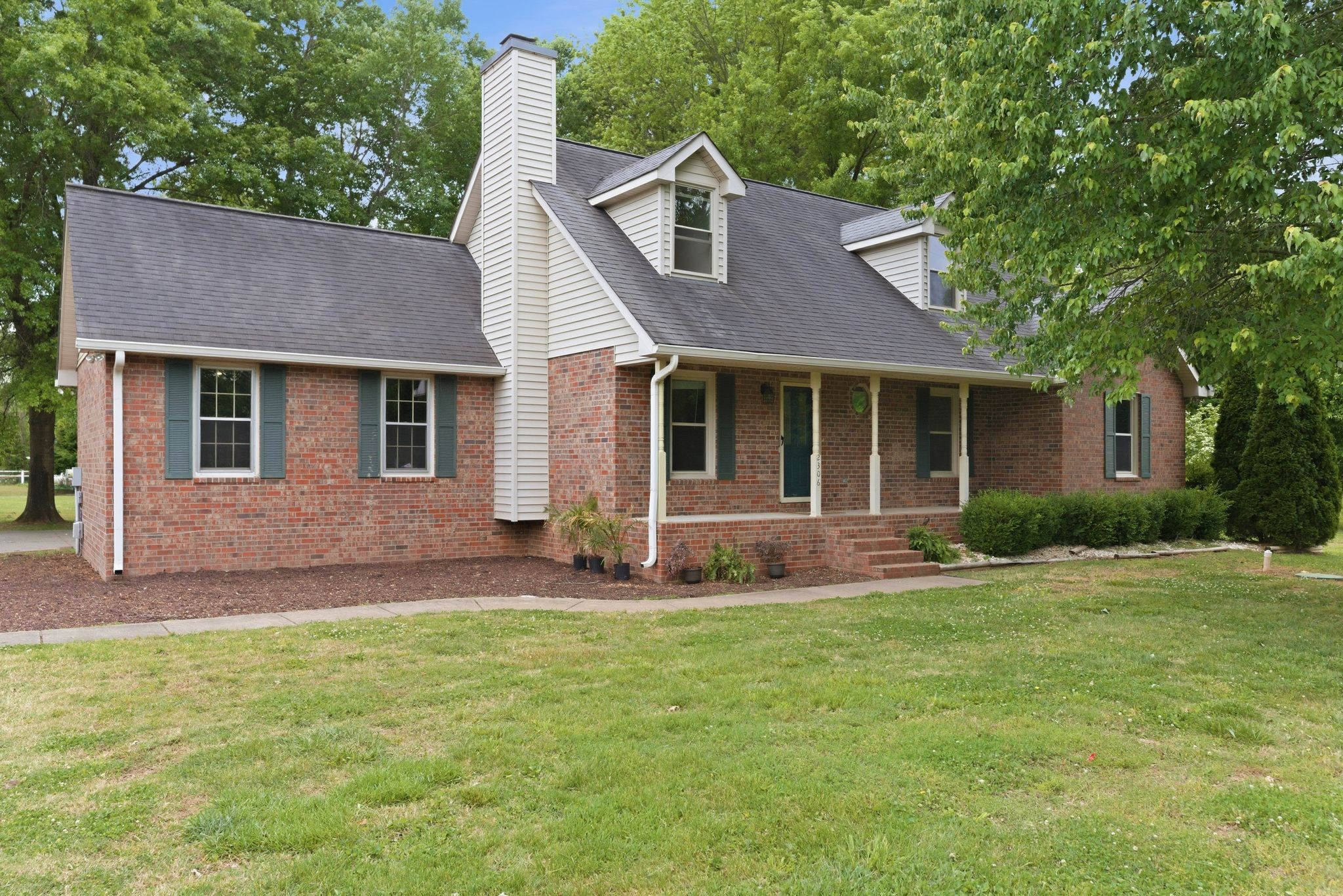 2306 Red Mile Road Murfreesboro, TN 37127 - Photo 20 of 23 a front view of a house with a garden and yard