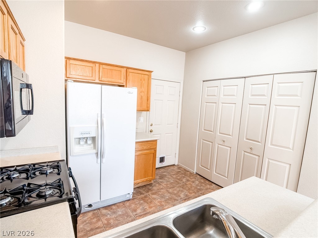 228 Positive Point Street Henderson, NV 89012 - Photo 6 of 27 Functional kitchen with ample cabinet space and modern appliances ready for your culinary adventures.