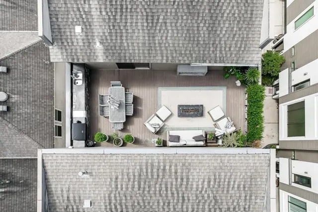 a terrace with outdoor seating and wooden floor