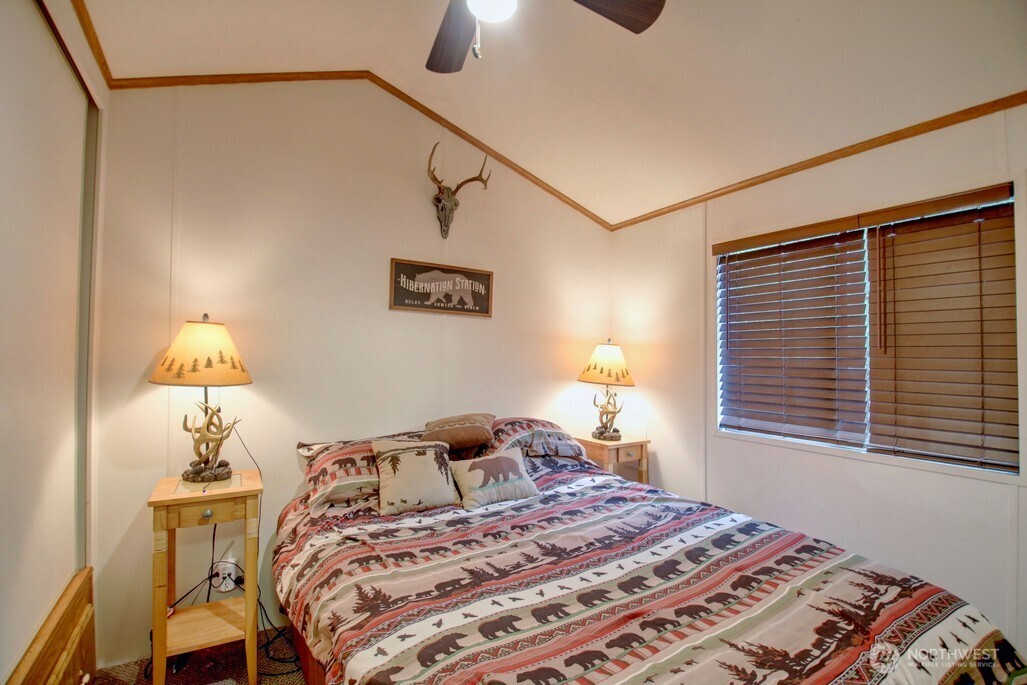 35 Branch Circle Maple Falls, WA 98266 - Photo 11 of 37 a bedroom with a bed and a night stand next to a window
