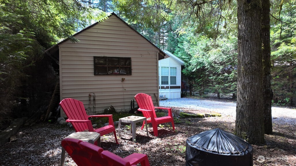 35 Branch Circle Maple Falls, WA 98266 - Photo 20 of 37 a backyard of a house with barbeque oven table and chairs