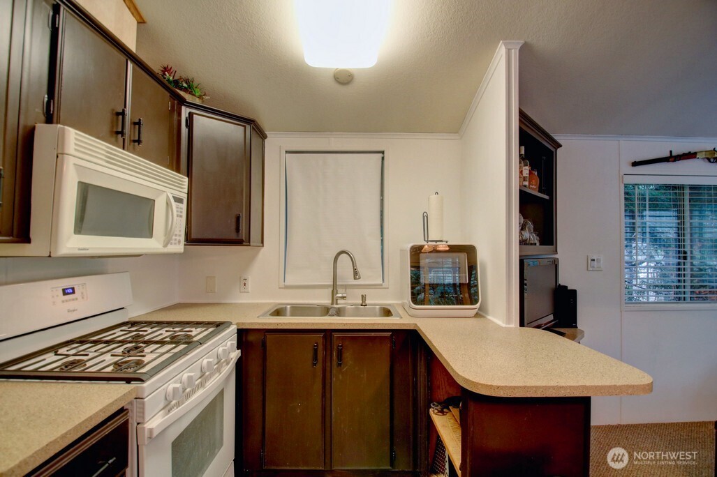 35 Branch Circle Maple Falls, WA 98266 - Photo 7 of 37 a kitchen with a stove and a microwave
