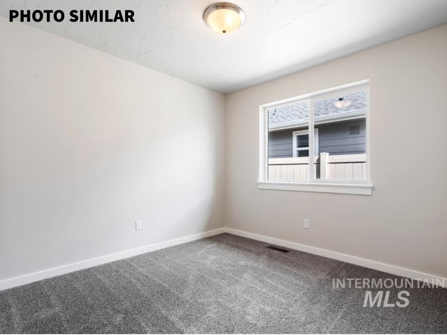 925 Twilight Weiser, ID 83672 - Photo 26 of 31 Room featuring neutral wall tones, gray carpeting, a single window, white trim, and a ceiling-mounted light fixture