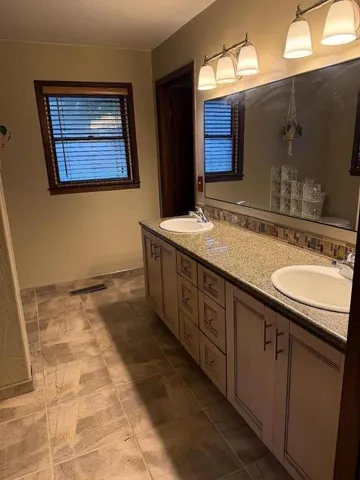 a bathroom with a sink a vanity and a mirror