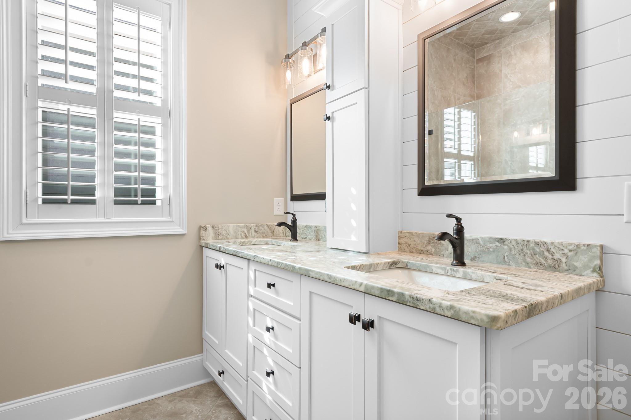 1215 Inn Keepers Way Cornelius, NC 28031 - Photo 11 of 35 a bathroom with a granite countertop sink and a mirror