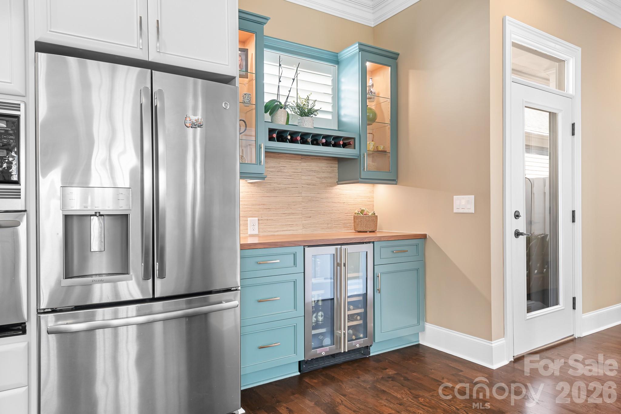 1215 Inn Keepers Way Cornelius, NC 28031 - Photo 4 of 35 a kitchen with stainless steel appliances granite countertop a refrigerator and a wooden floor