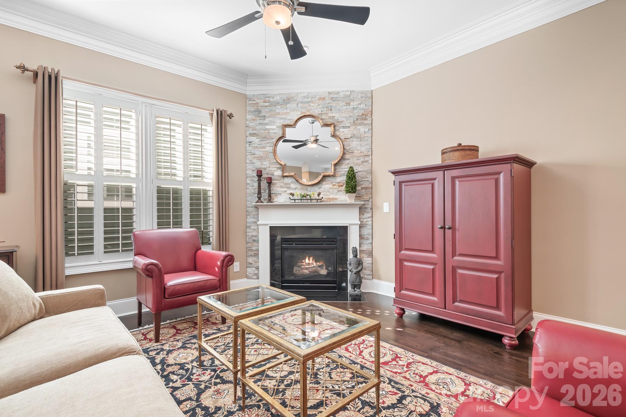 1215 Inn Keepers Way Cornelius, NC 28031 - Photo 7 of 35 a living room with furniture a dining table and a fireplace