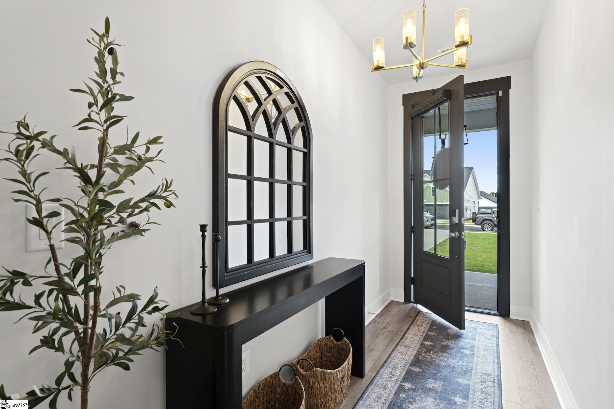 164 Laurel Oak Drive Anderson, SC 29621 - Photo 3 of 42 Welcoming entryway with beautiful front door, wide hallway, LVP flooring and modern lighting.