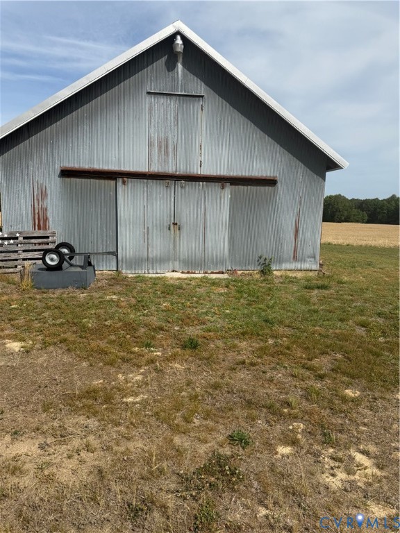 9380 Wakefield Road Wakefield, VA 23888 - Photo 8 of 11 Corrugated metal barn with a pitched roof and slid
