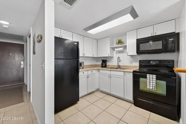 a kitchen with stainless steel appliances a sink and cabinets