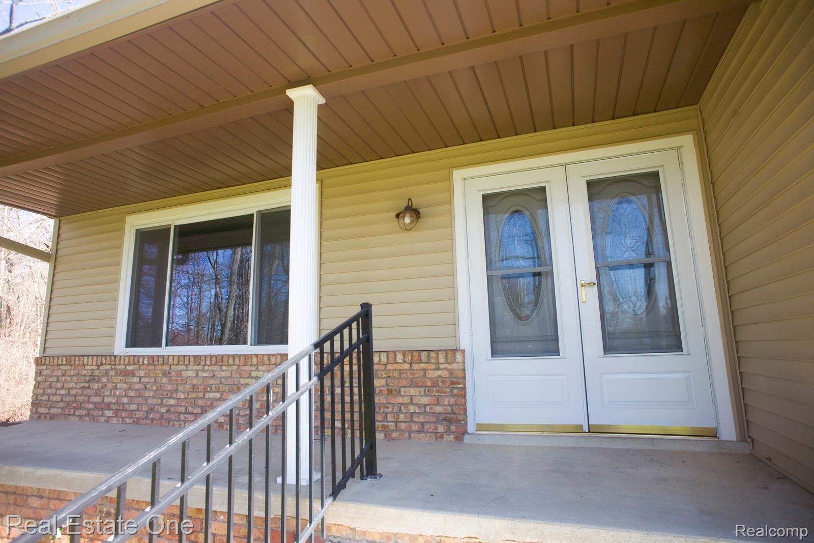 42560 Willis Road Belleville, MI 48111 - Photo 4 of 70 NICE COVERED FRONT PORCH FOR SUMME PORCH SITTING, DOUBLE DOOR ENTRY TO LIVING ROOM.