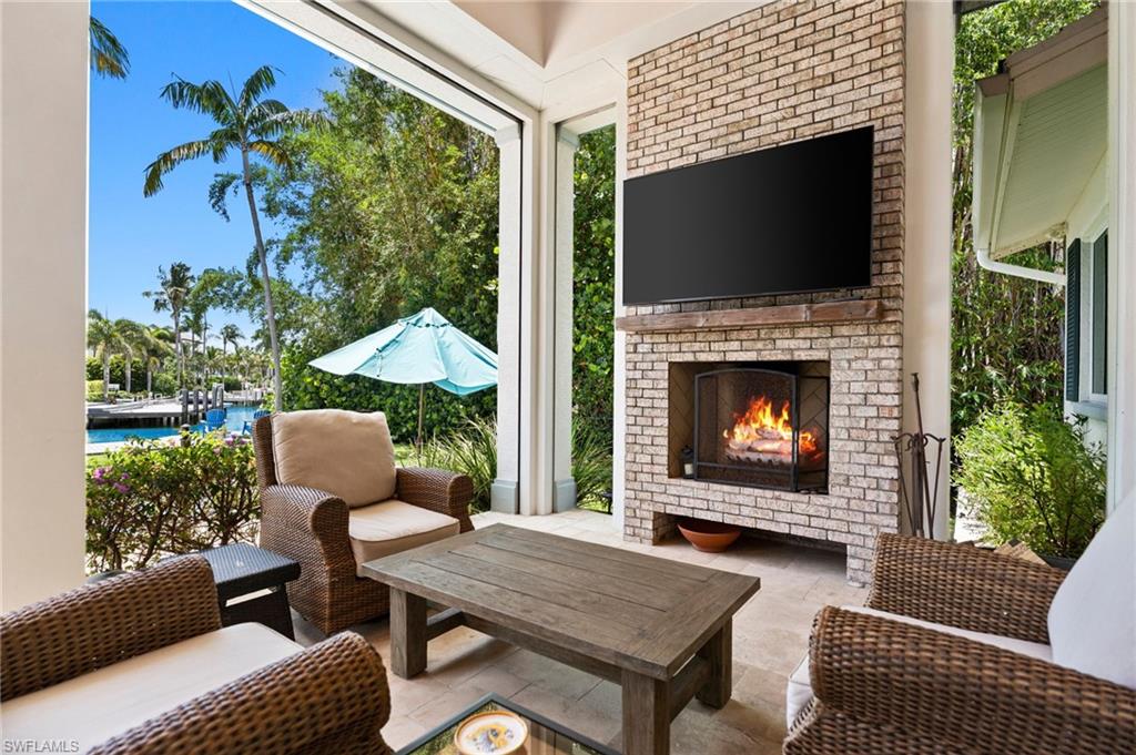 2201 Beacon Lane Naples, FL 34103 - Photo 4 of 25 a outdoor living space with furniture and a fireplace