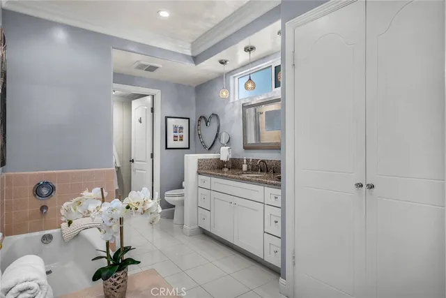 a bedroom with furniture wooden floor and a large window