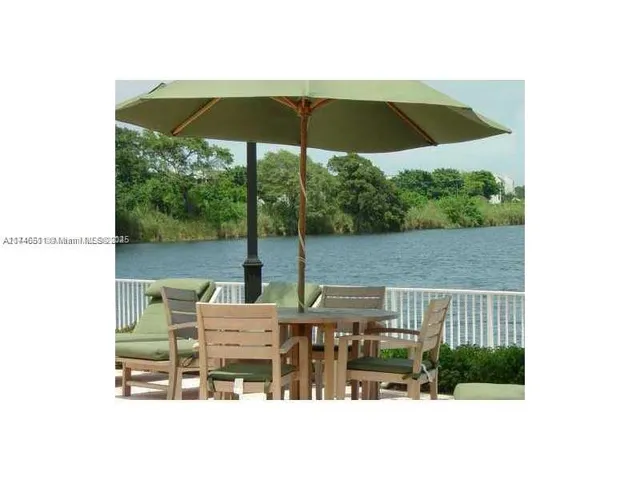 a balcony view with a table and chairs