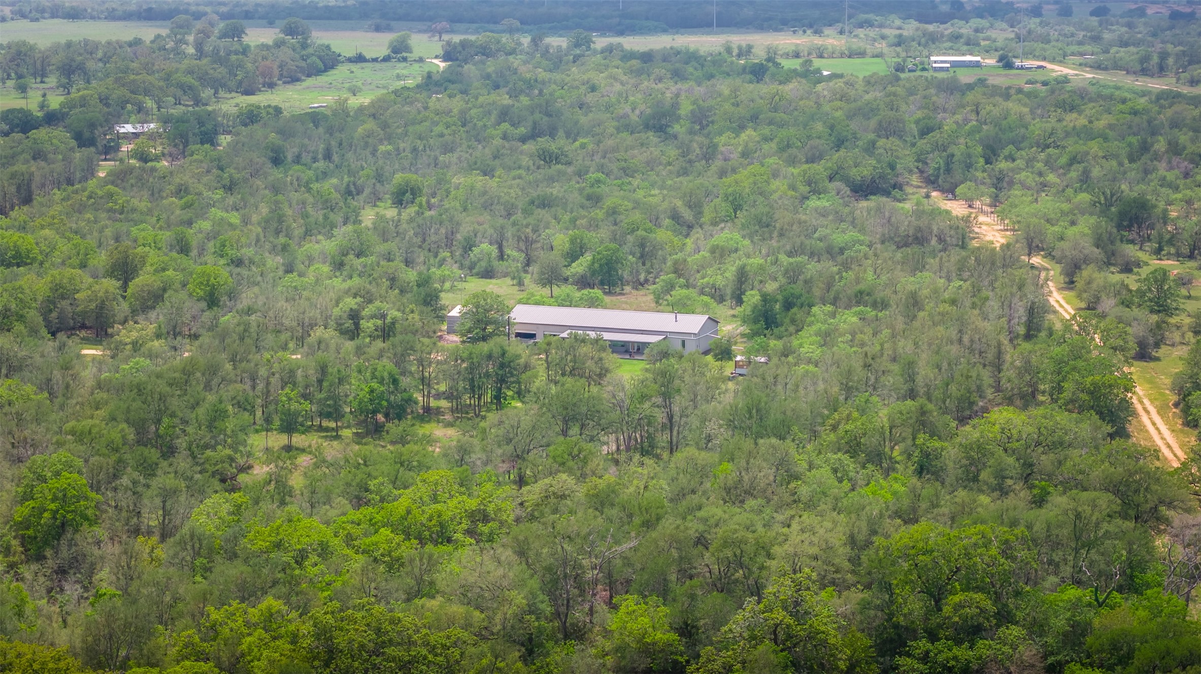 4082 Old Colony Line Road Lockhart, TX 78644 - Photo 33 of 40 Secluded dwelling amidst a dense canopy of mature trees, offering ultimate privacy and tranquility.