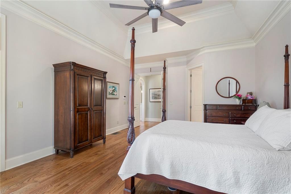 1665 High Trail Southeast Atlanta, GA 30339 - Photo 25 of 53 a bedroom with a bed and a chandelier