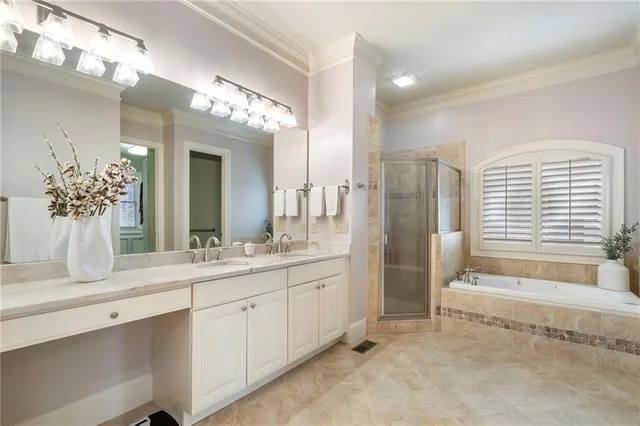 a bathroom with a double vanity sink mirror and shower