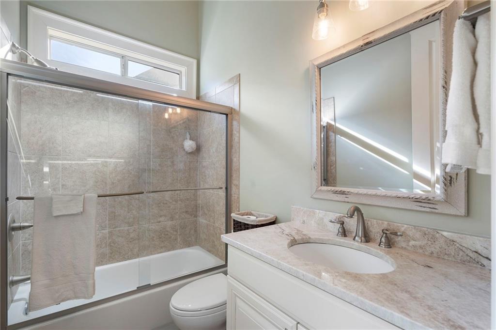 1665 High Trail Southeast Atlanta, GA 30339 - Photo 32 of 53 a bathroom with a granite countertop bathtub shower sink mirror and toilet