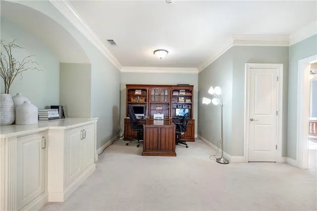 a bedroom with a bed chandelier and a window