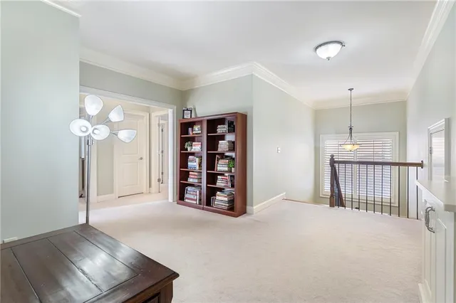 a bedroom with a bed gym equipment and a chandelier