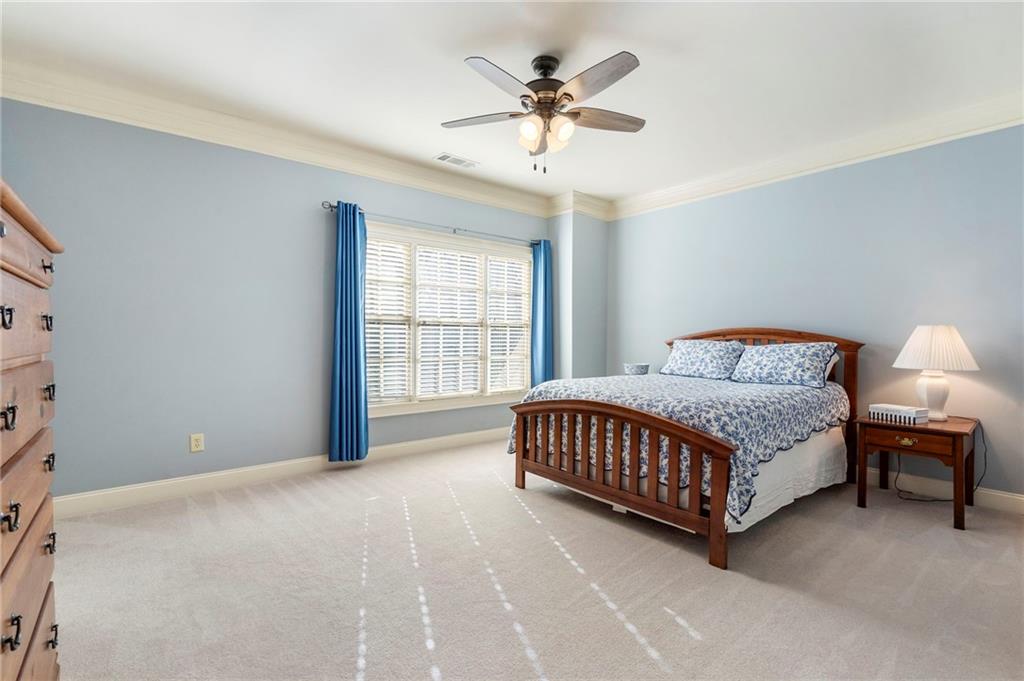 1665 High Trail Southeast Atlanta, GA 30339 - Photo 36 of 53 a bedroom with a bed chandelier and a window