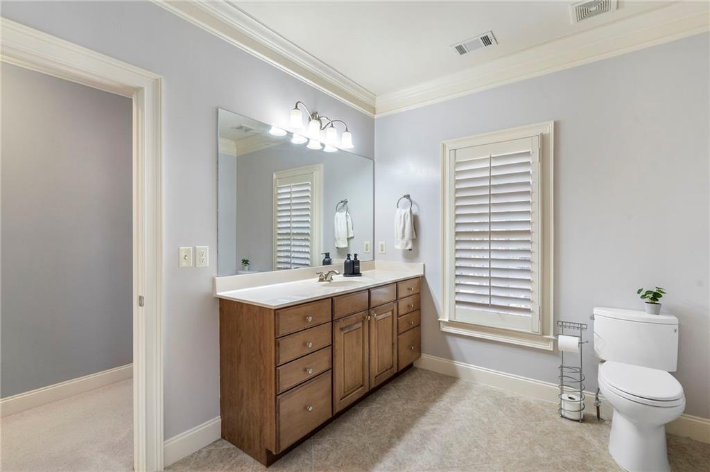 1665 High Trail Southeast Atlanta, GA 30339 - Photo 41 of 53 a bathroom with a toilet sink and mirror