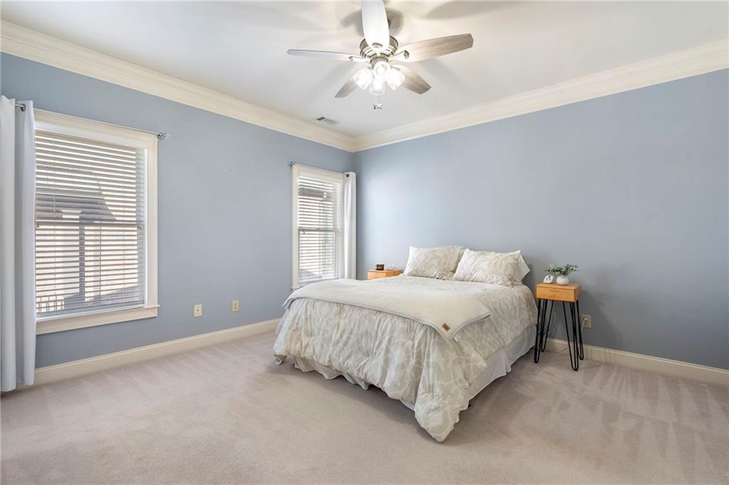 1665 High Trail Southeast Atlanta, GA 30339 - Photo 42 of 53 a spacious bedroom with a bed and a chandelier