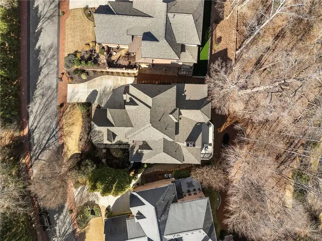 an aerial view of a house with a yard