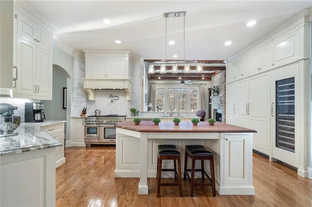 a kitchen with a stove and a wooden floor