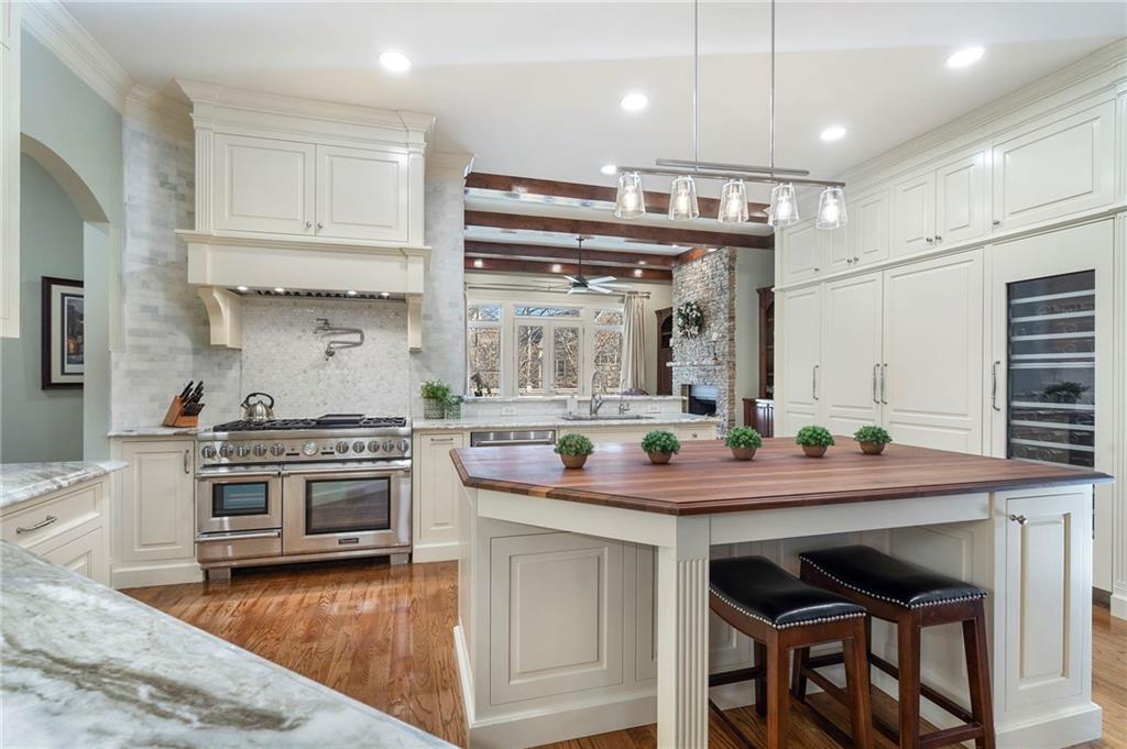 1665 High Trail Southeast Atlanta, GA 30339 - Photo 8 of 53 a kitchen with a stove and a wooden floor