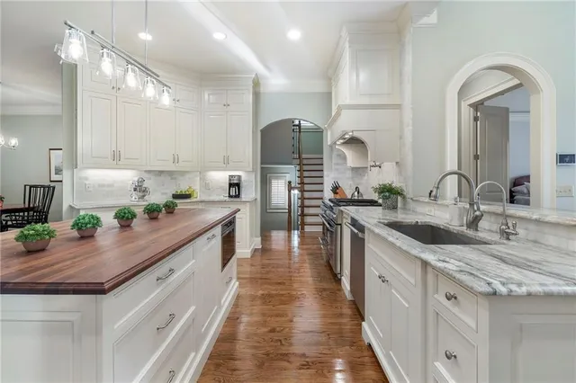 a kitchen with stainless steel appliances granite countertop a stove a sink and a refrigerator