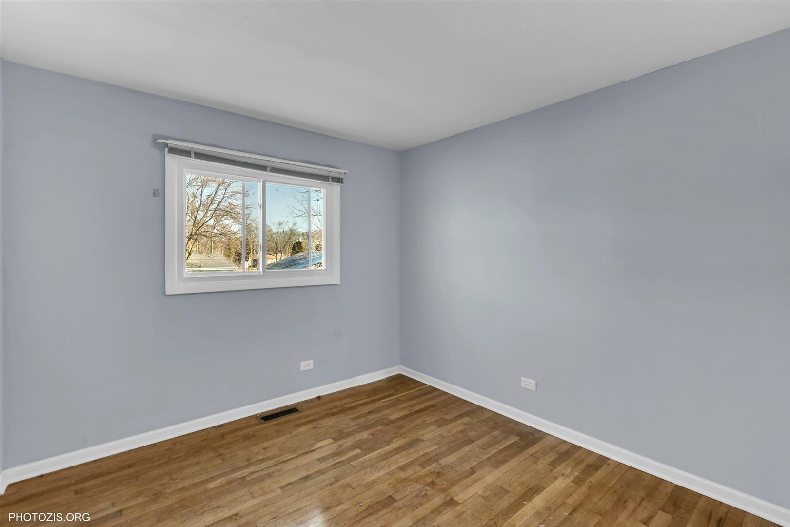 465 Washington Boulevard Hoffman Estates, IL 60169 - Photo 17 of 26 a view of an empty room with wooden floor and a window