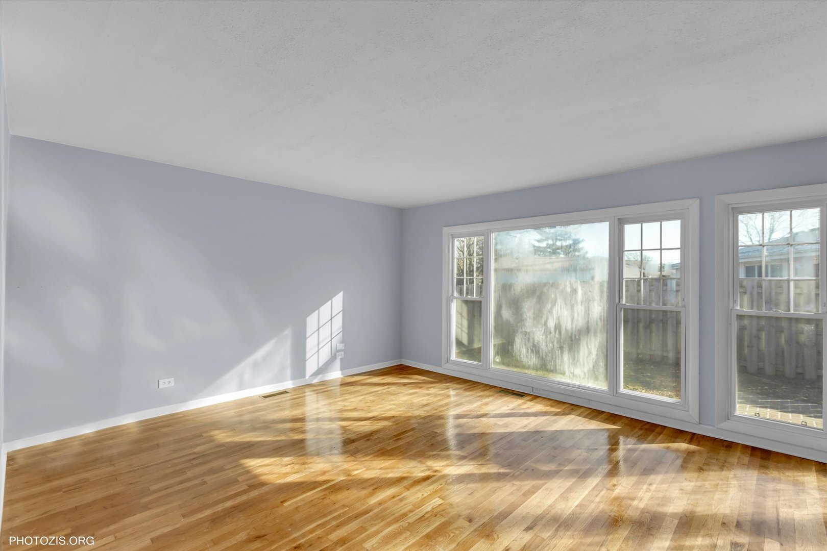 465 Washington Boulevard Hoffman Estates, IL 60169 - Photo 9 of 26 a view of empty room with wooden floor and fan