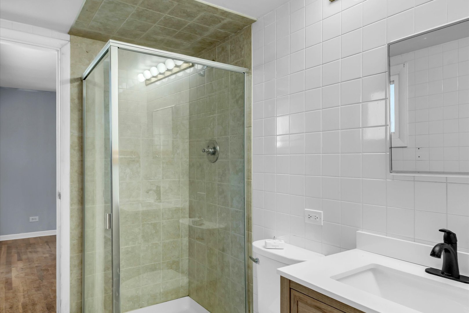 465 Washington Boulevard Hoffman Estates, IL 60169 - Photo 10 of 26 a bathroom with a sink and shower