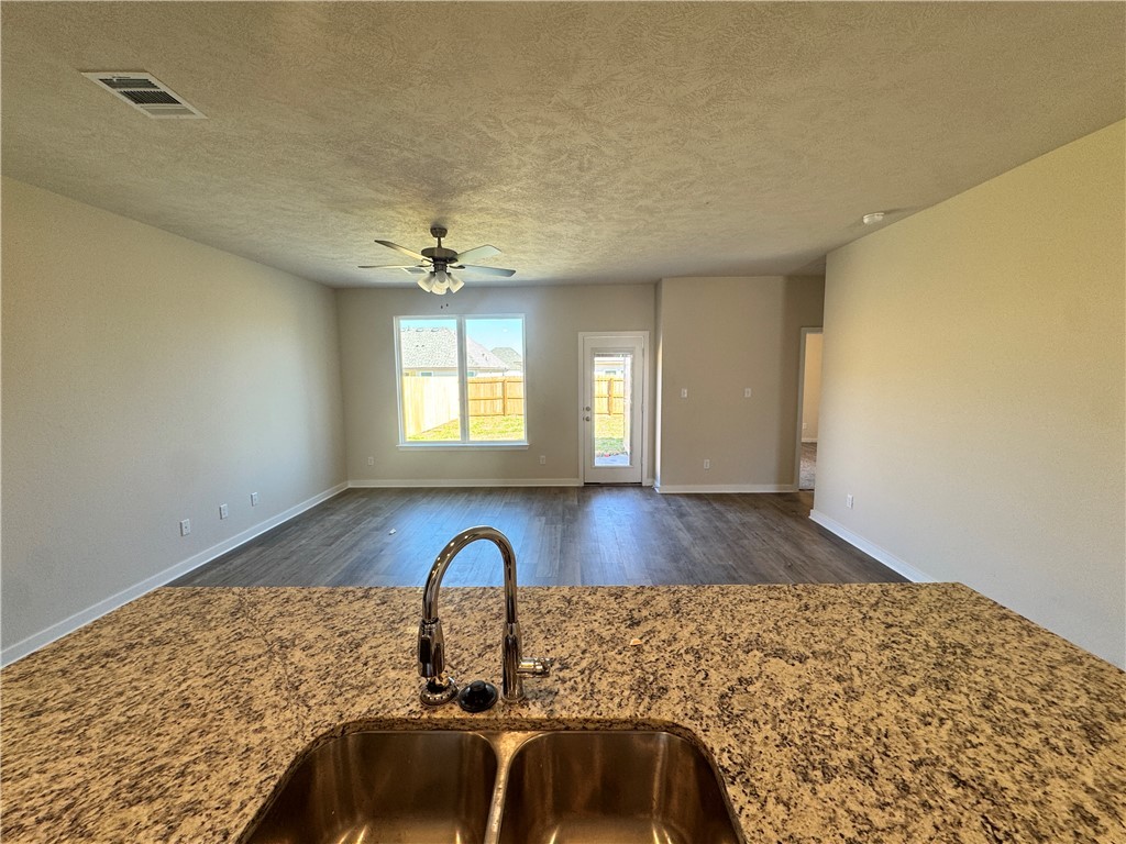 2414 Rooke Road Bryan, TX 77807 - Photo 11 of 11 a view of a livingroom with wooden floor and a ceiling fan
