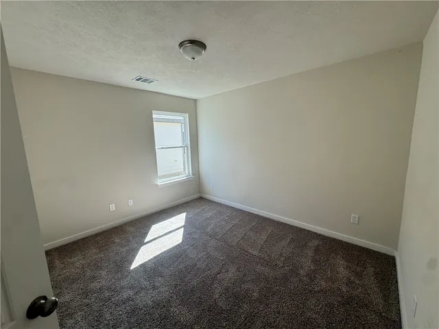 a view of a livingroom with wooden floor and a ceiling fan