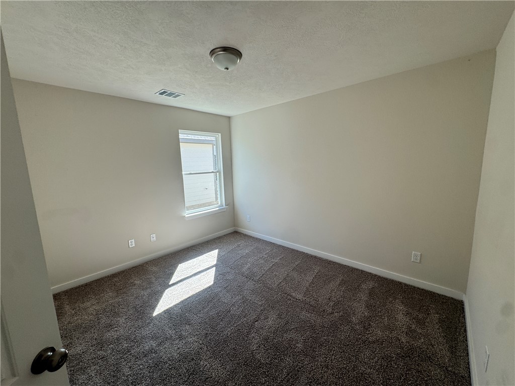 2414 Rooke Road Bryan, TX 77807 - Photo 5 of 11 an empty room with windows