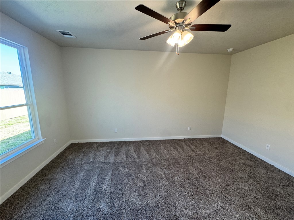 2414 Rooke Road Bryan, TX 77807 - Photo 8 of 11 an empty room with a window and a fan
