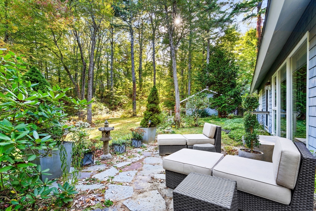 a view of backyard of house with seating area