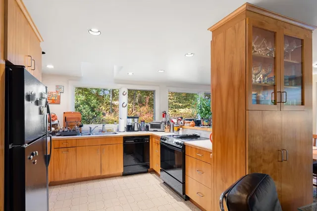 a kitchen that has a sink stainless steel appliances a counter top space and cabinets