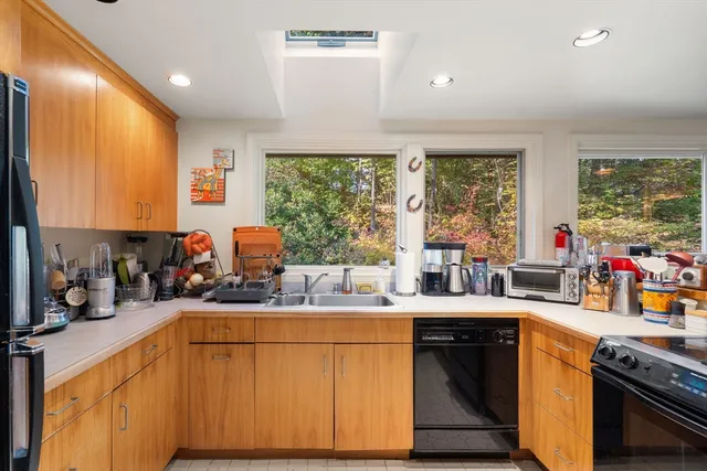 a kitchen with stainless steel appliances granite countertop a sink stove and cabinets