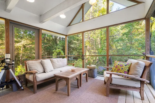 a living room with furniture and a floor to ceiling window