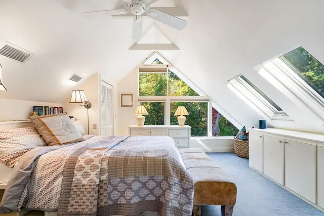 a bedroom with a bed and a large window