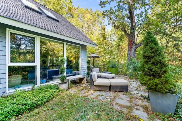 a backyard of a house with outdoor seating