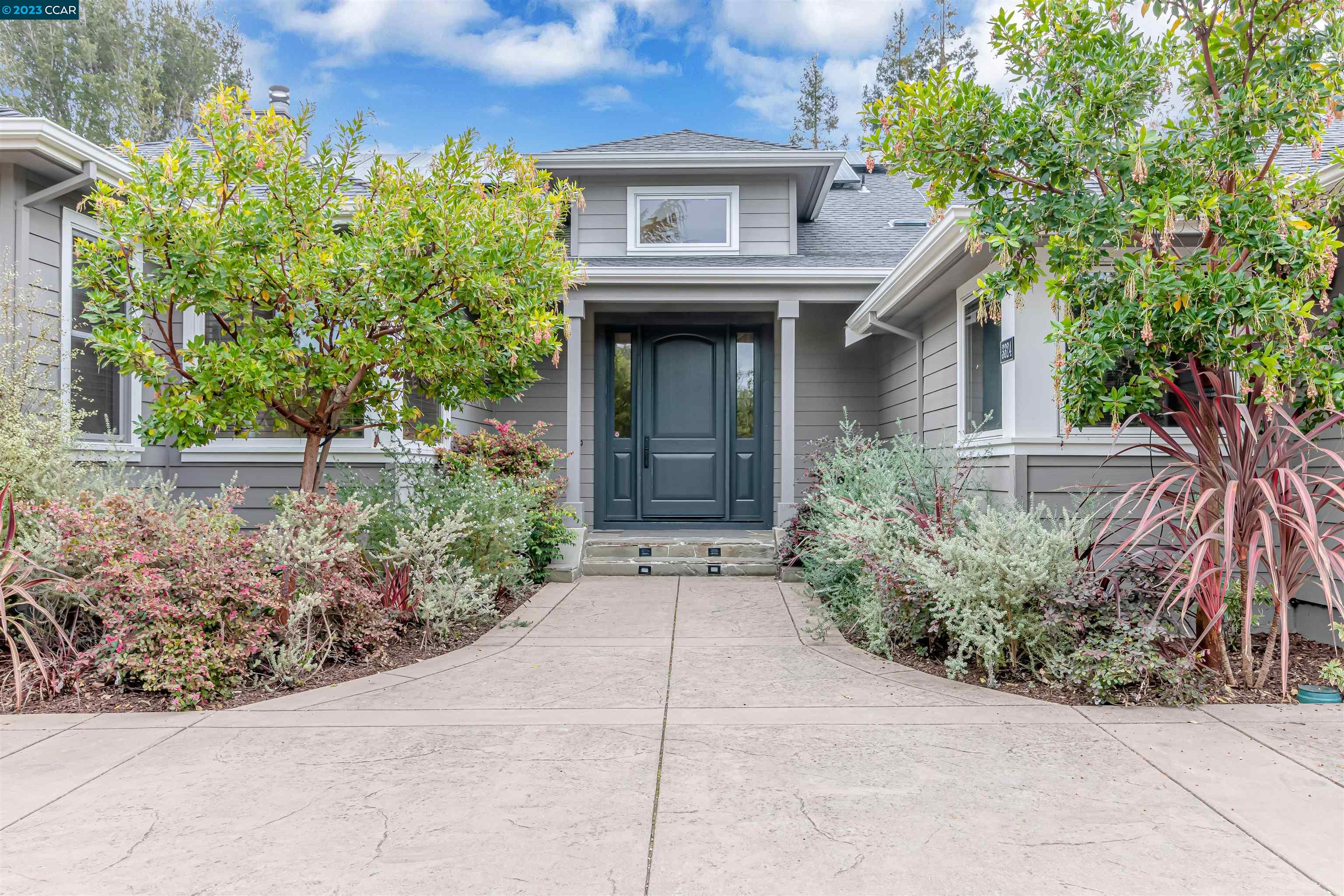 a view of house with outdoor space and garden